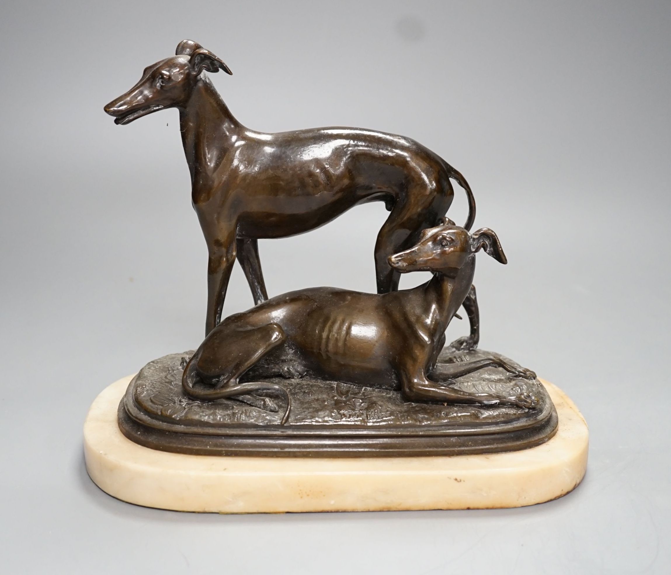 A bronze sculpture of a greyhounds on alabaster base, one seated and the other standing - 20cm high